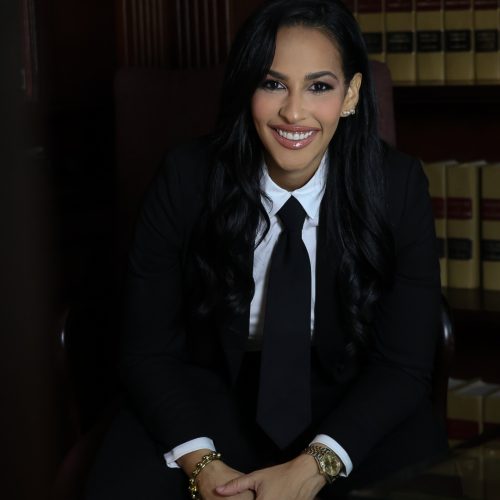 Portrait of Mariel Colón Miró, criminal defense attorney, seated in her law office